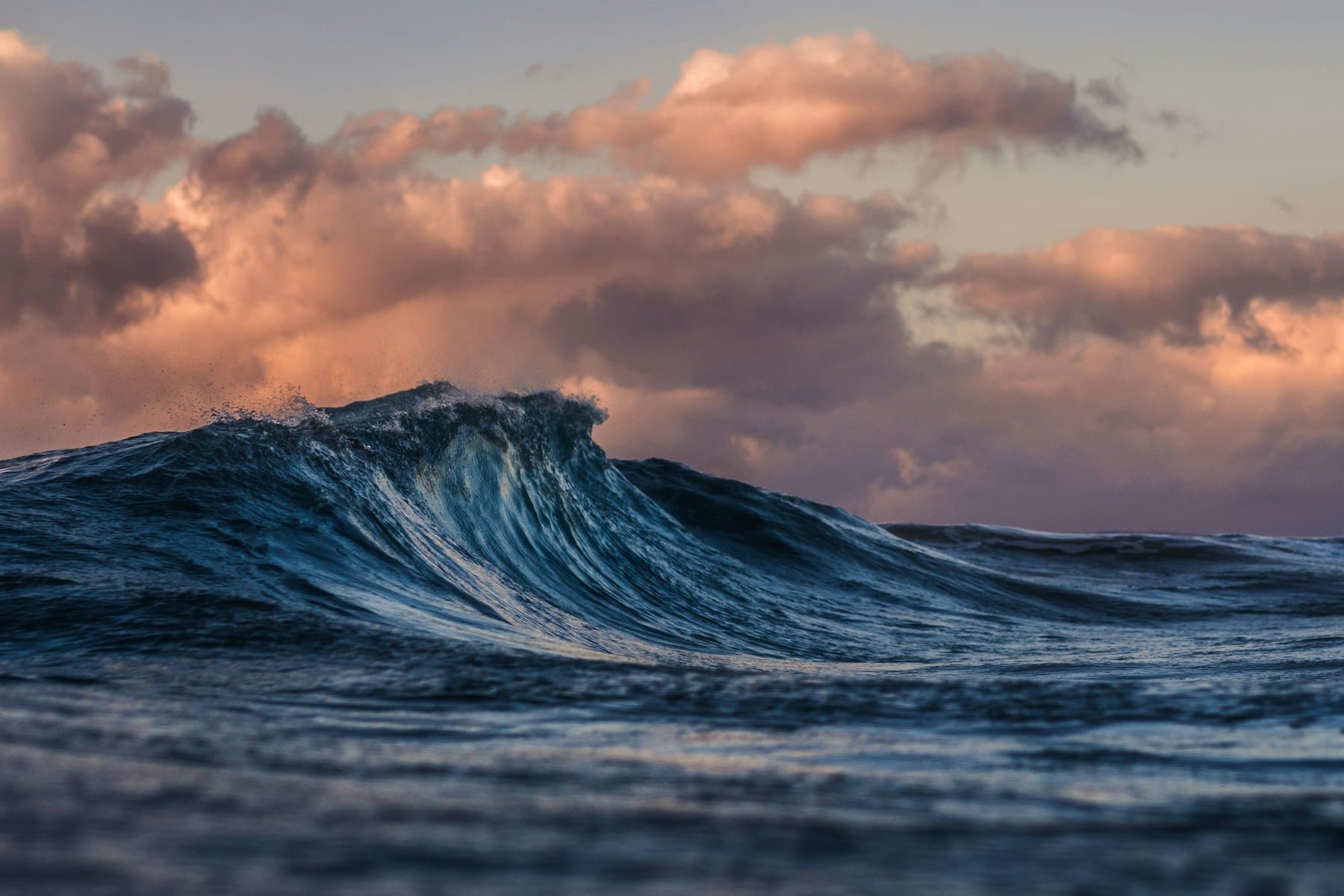 A slow wave under an evening sky