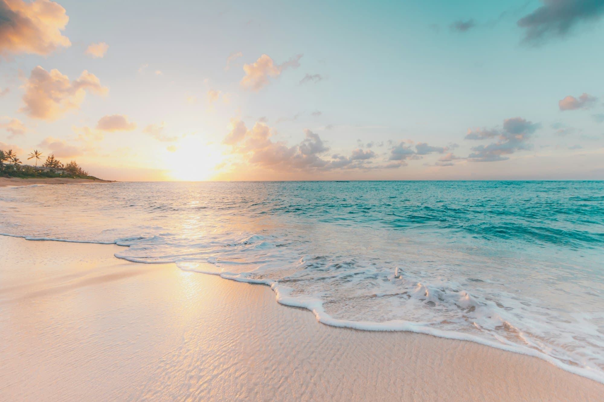 Quiet shoreline with gentle waves at sunset